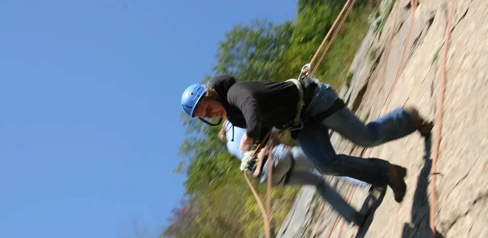 Woman rappelling face first in an Australian rappelling technique